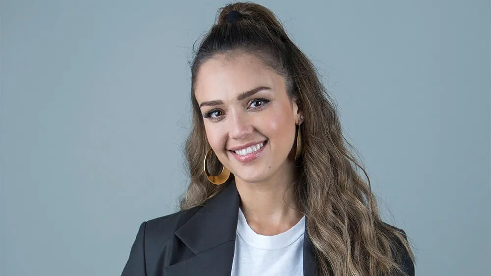 Jessica Alba, co-founder of The Honest Company, smiling in a professional portrait.