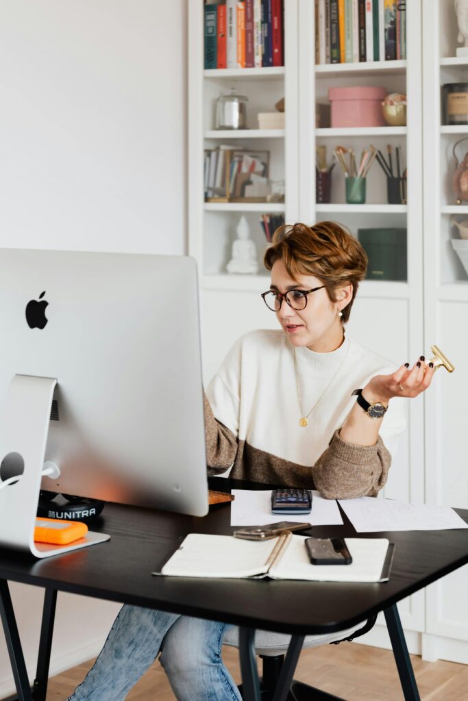 A small business owner reflecting at her desk, illustrating the moment entrepreneurs realize their website no longer fits their brand.