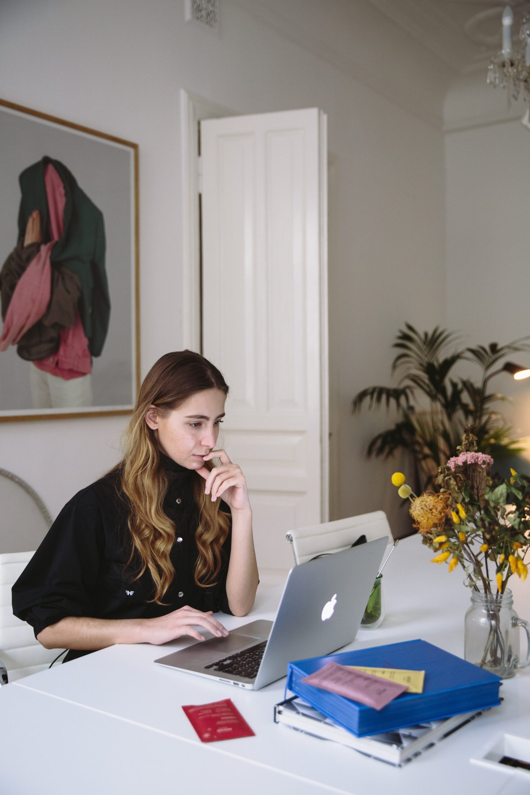 A woman reviewing her website layout on a laptop, capturing the focus and clarity of refining website user experience.