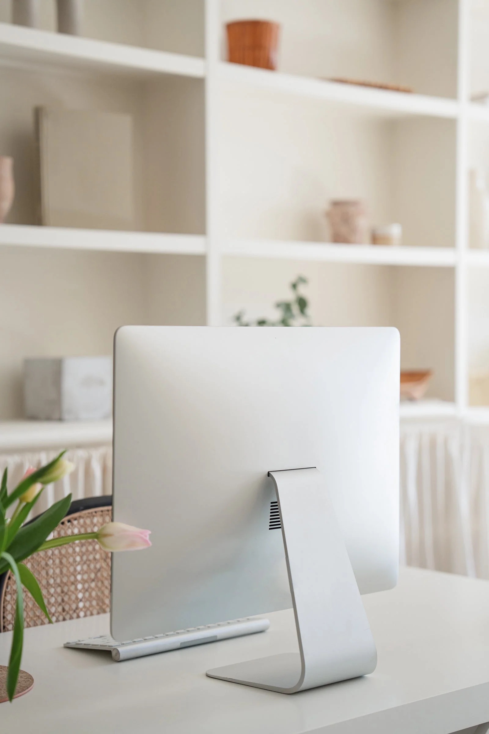 A clean, organized desk with a desktop computer, representing the clarity that comes from simple business systems.